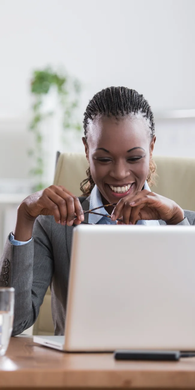 Person smiling while working on laptop, representing integration development.