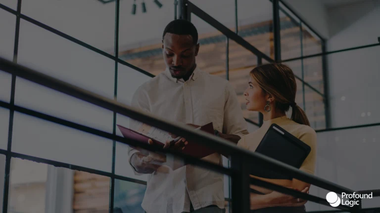 A man and a woman walking while talking about work