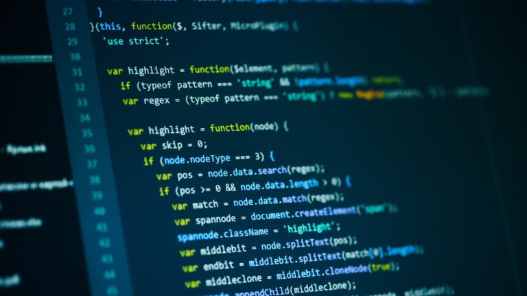 JavaScript source code displayed on a monitor.