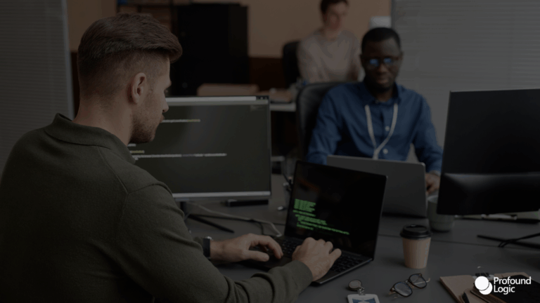 Male junior developer sitting at a computer.